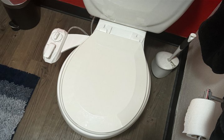  White Luxe Bidet Neo 320 budget bidet attachment displayed on a closed toilet