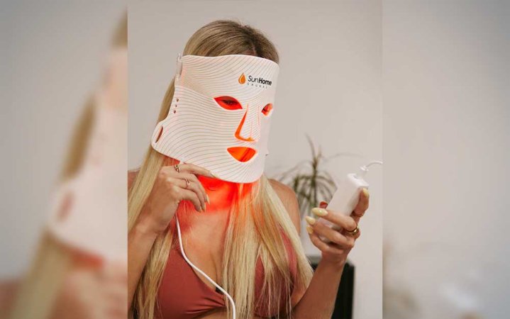  A woman wearing a Sun Home Saunas LED face mask