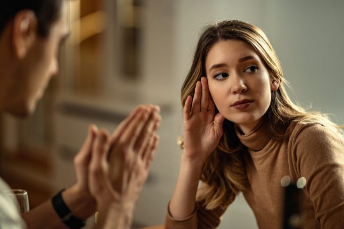 young displeased woman ignoring her boyfriend who is begging forgiveness 1200x800.jpg